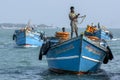 Men steer a transport boat (ferry) into the port at Kurikadduwan in northern Sri Lanka.