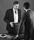 Men in suit or businessmen meet for handover of black