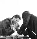 Men in suit or businessmen with screaming face compete in armwrestling on table on white background. Winner and defeated Royalty Free Stock Photo