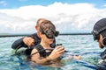 A man in a suit for diving prepares a boy to dive Royalty Free Stock Photo