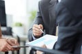 Businessman and woman discussing on stockmarket charts in office. Men in a suit hold a clipboard with financial charts. Royalty Free Stock Photo