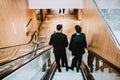 4 men in suit in the shopping center or buisnes center.