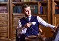 Men in suit sit in library or retro interior, defocused. Royalty Free Stock Photo