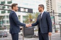 Men in suits handover briefcase outdoor. Business deal. Two business man hold business briefcase. Business transfer deal Royalty Free Stock Photo