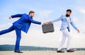 Men suits handover briefcase. Rascal racketeer extortionist cheating business transaction. Risky transaction. Fraud and Royalty Free Stock Photo