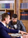 Men in suits, oldfashioned professors, scientists in library with books Royalty Free Stock Photo