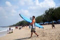 Men with surfboards at famous Kuta Beach in Bali