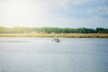 Men are swimming on an inflatable motor boat on the river Royalty Free Stock Photo