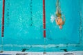 Men swimming in a pool in blue water