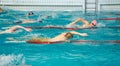 Men swimming in a pool in blue water