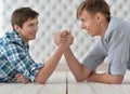 Men at the table and armwrestling Royalty Free Stock Photo