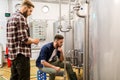 Men with tablet pc at craft beer brewery kettle Royalty Free Stock Photo