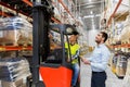 Men with tablet pc and forklift at warehouse Royalty Free Stock Photo