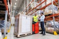 Men with tablet pc and forklift at warehouse Royalty Free Stock Photo