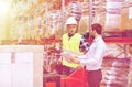 Men with tablet pc and forklift at warehouse Royalty Free Stock Photo