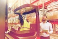 Men with tablet pc and forklift at warehouse Royalty Free Stock Photo