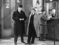 Men talking in theater lobby