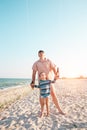 A man is teaching his son kitesurfing. Royalty Free Stock Photo