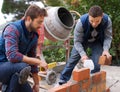 Men, tools and bricks in outdoor with cement for construction, building or masonry for job or skill. Young people Royalty Free Stock Photo