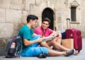 Men tourists sitting with beer