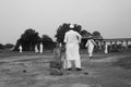 Men in traditional attire play cricket, Sarkhej Roza Royalty Free Stock Photo