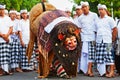 Men in traditional costumes with mask of Balinese spirit Barong