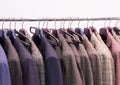 Men trousers and jackets on hangers . Selective focus. Royalty Free Stock Photo