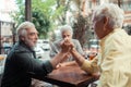 Men trying arm-wrestling while sitting outside pub Royalty Free Stock Photo