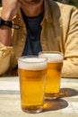 Men with two glasses of fresh cold lager beer in French outdoor cafe Royalty Free Stock Photo