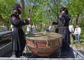 Men in uniform of soldiers of Ukrainian Peoples Republic army banging vintage battle drums.