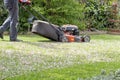 Men use lawnmowers in the front yard. Royalty Free Stock Photo