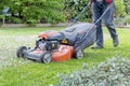 Men use lawnmowers in the front yard. Royalty Free Stock Photo