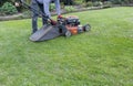 Men use lawnmowers in the front yard. Royalty Free Stock Photo