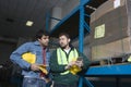 Men Using Calculator In Factory Royalty Free Stock Photo