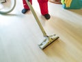 Men vacuum the floor holding with steam homemaker