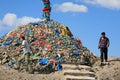 Men walking around an ovoo, Mongolia. Royalty Free Stock Photo