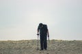 Men walking on beach metal detector.