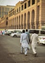 3 men walking in the city of Medina