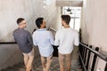 men walking down office stairs and talking Royalty Free Stock Photo