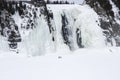 Men walking near frozen waterfall