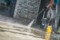 Men Washing Driveway