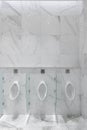 Men wc urinal area in white marble tile mood / interior design / background / elevation