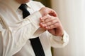 Men wear cufflinks on a shirt sleeve Royalty Free Stock Photo