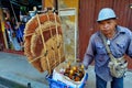 Men wear hat,shirt in blue jean bike parking and bottled honey and honeycomb for sale to tourists