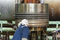 Marine engineer assembling a piston to the large double stroke main engine of merchant ship. Royalty Free Stock Photo