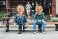 Men Wearing Oversized Barack Obama Masks Sit On Picnic Bench