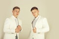 Men wearing white jackets on grey background Royalty Free Stock Photo