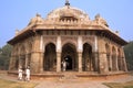 Men in white dresses walking at Isa Khan Niyazi tomb, Humayun's