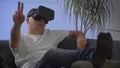 Men in white shirt enjoying vr on sofa virtual reality googles