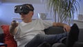 Men in white shirt enjoying vr on sofa virtual reality googles